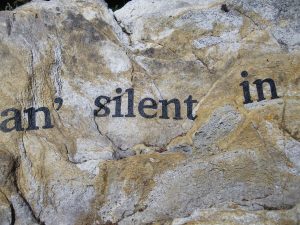 letters on stone spelling "an' silent in"